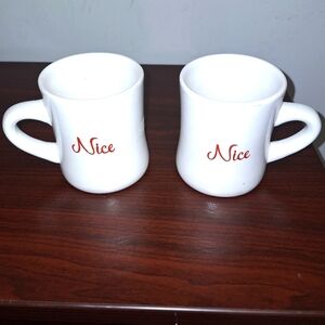A pair of Naughty and Nice coffee mugs. Dishwasher and microwave safe.
